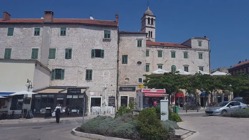Across the bay the Sibenik old town waterfront gives you stone squares, konobas and cafes a short hop from the marina.