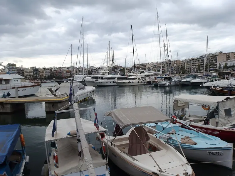 A forest of masts stands over the inner pontoons, where cruising sailboats raft close together within sight of the passenger port's ferry terminals.