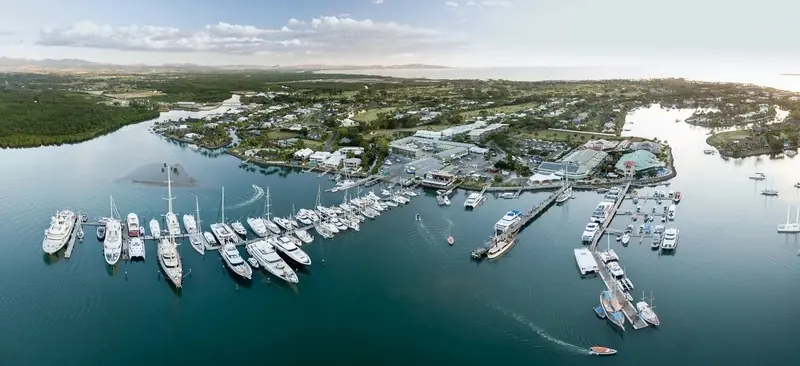 An aerial view of Port Denarau's berths, the marina channel and the resort strip on the shore behind it