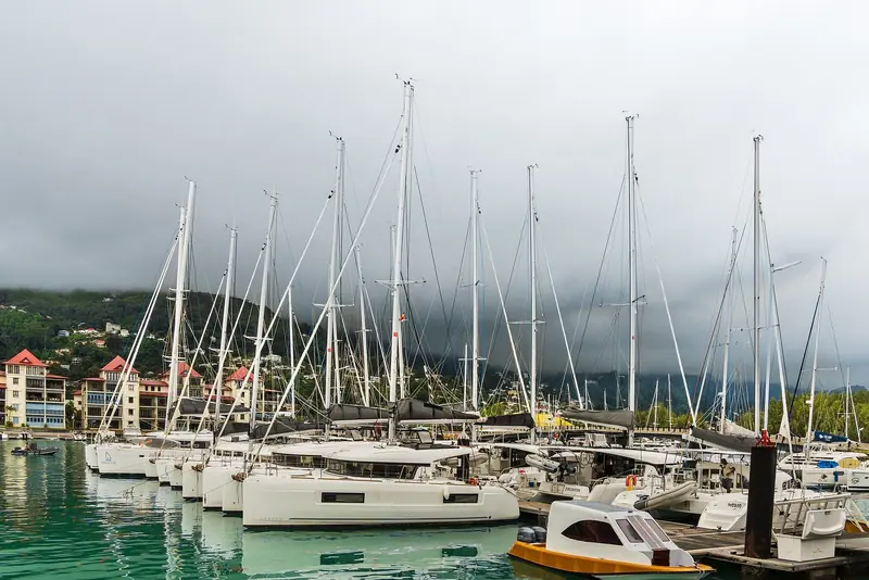 Charter catamarans lined up on their berths, the fleet that gives Eden Island its business as a Seychelles cruising base as much as a superyacht stop