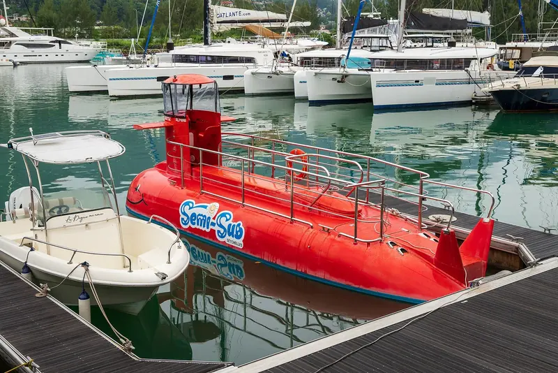 A tourist semi-submersible tied up among the leisure fleet, one of the everyday charter operations run out of the marina