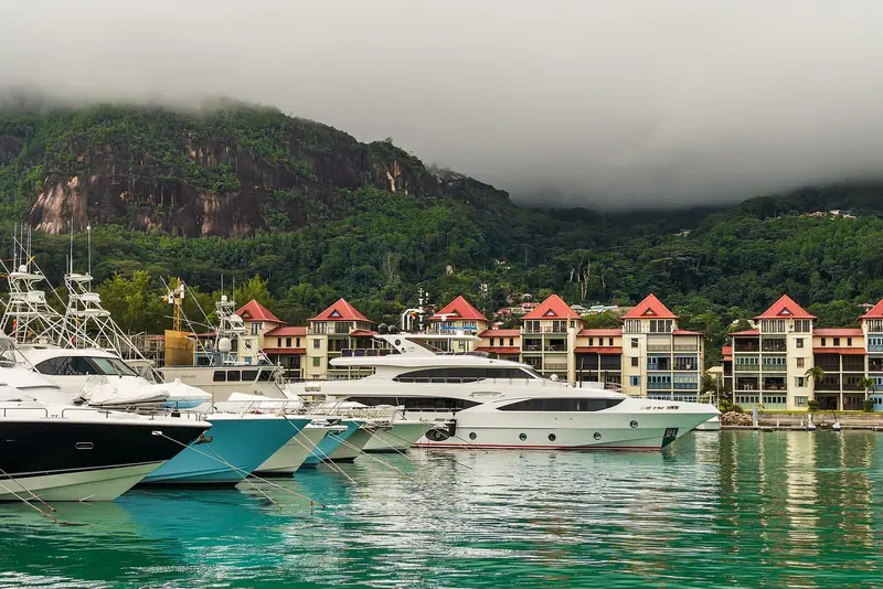 Sportfishing and motor yachts on the finger berths below Eden Plaza's red-roofed marina building