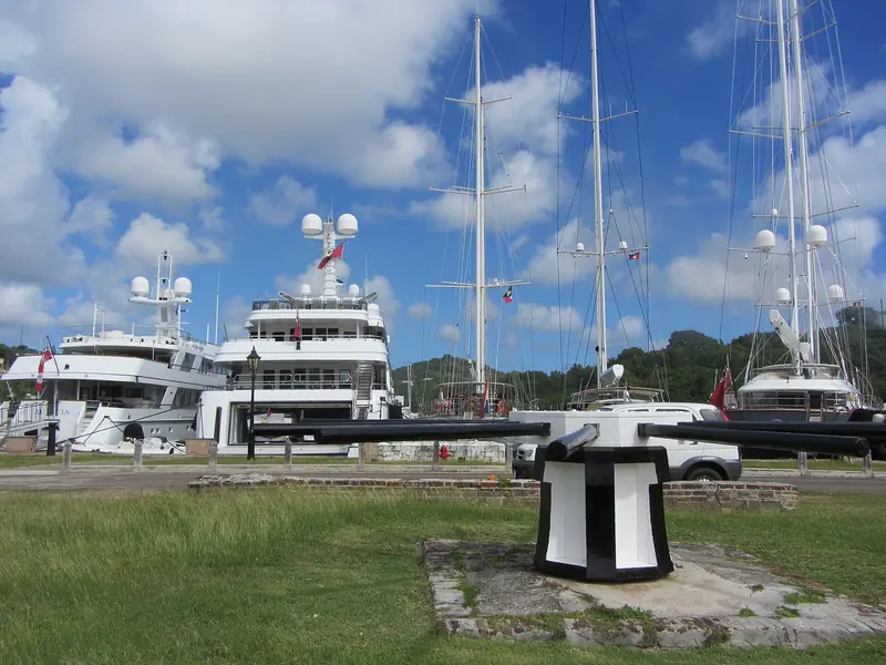 Superyachts alongside in English Harbour. Berths of this size in Antigua are counted, not assumed, and December fills them.