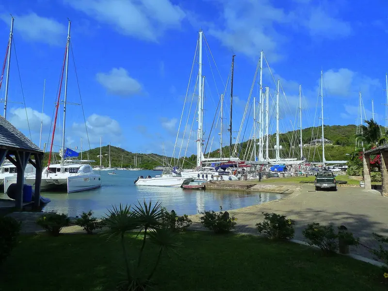 Yachts alongside in English Harbour with the green hills behind. Shelter here is the reason the Navy chose it in the first place.