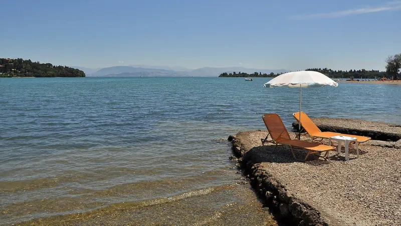 Gouvia Bay. The marina sits inside this shallow, almost enclosed bay, and that is where its shelter and its summer heat both come from.