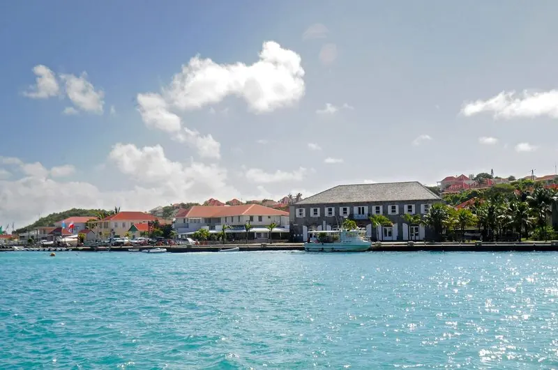 The old stone warehouse on the quay still anchors the waterfront, with workboats and tenders lying alongside in the middle of town.