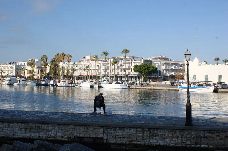 Kos town's waterfront and hotel frontage, seen across the harbour from the old fortress side.