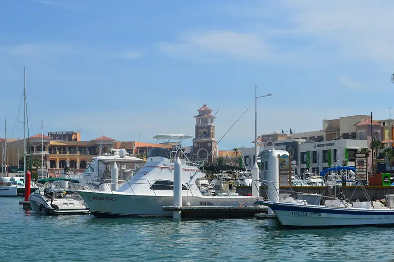 The marina's lighthouse tower and walkway. The state that owns this harbour took physical control of it for a day in April 2024, a fact IGY's own marketing has never mentioned since.