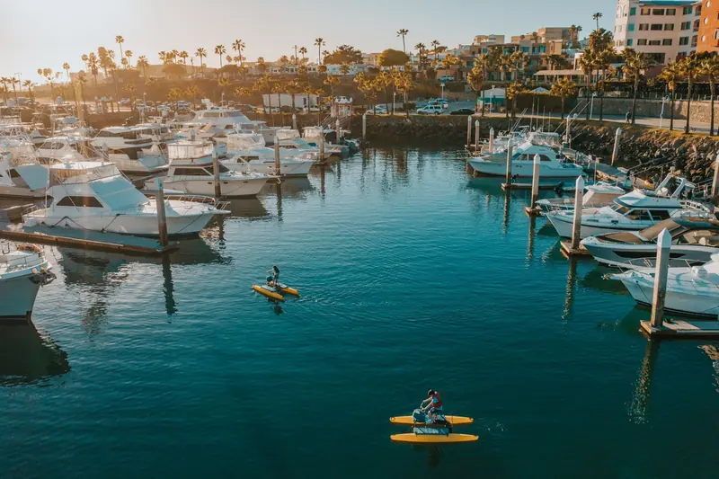 Sunset along the fairway between rows of sport-fishers and motoryachts, hydrobikes crossing the basin below the hotel.