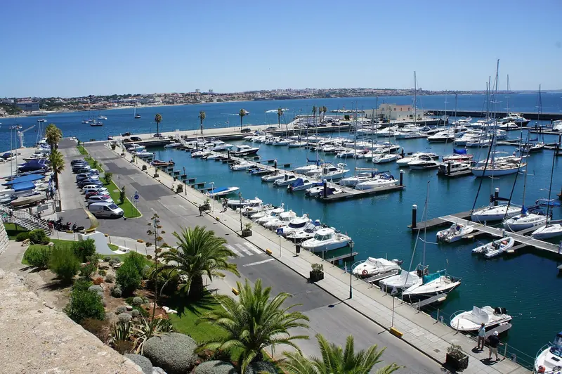 Marina de Cascais from above the quay. The basin is dug into the shore below the town, a short walk from the station that puts you in Lisbon in forty minutes.