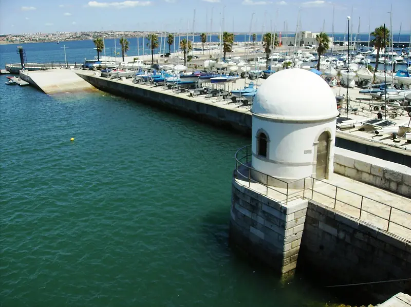 The old tide-gauge house at the entrance. Cascais measured Portugal's sea level here, which is why the datum for the whole country is this spot.