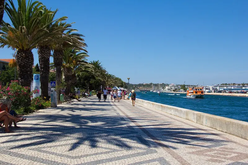 The esplanade running north along the Bensafrim river past the marina toward the old town.