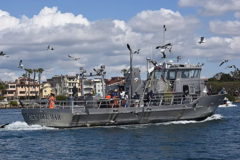 A sportfishing boat entering the harbour past the Marina del Rey waterfront condos. This is one of over twenty separately operated basins that together make up the harbour.