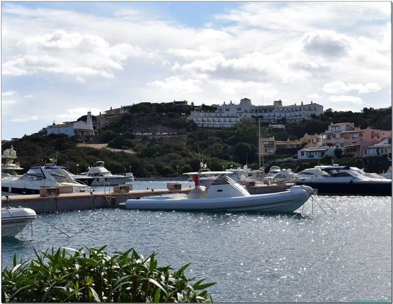 Motor boats and sailing yachts lie packed on the pontoons, the bare granite ridge behind the village giving the basin its shelter.