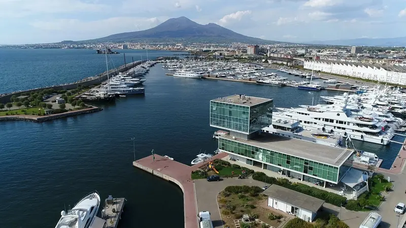 The marina from the air, with Vesuvius on the skyline behind the control tower and the megayacht quay
