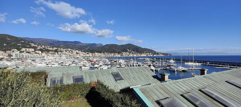 Marina di Varazze in full summer light, with the Riviera di Ponente running east toward Genoa.