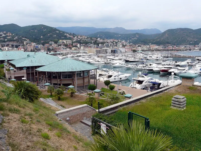 The marina's own restaurant pavilions sit right on the quay, with berths for motor yachts stretching behind them.