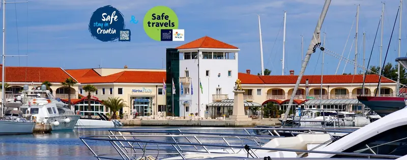 The reception building and berths on the main quay, terracotta roofs typical of the resort's Dalmatian styling.