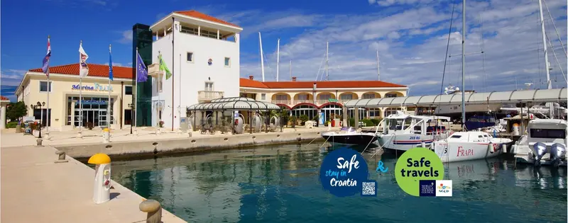 The marina office and adjoining hotel building seen from the water.