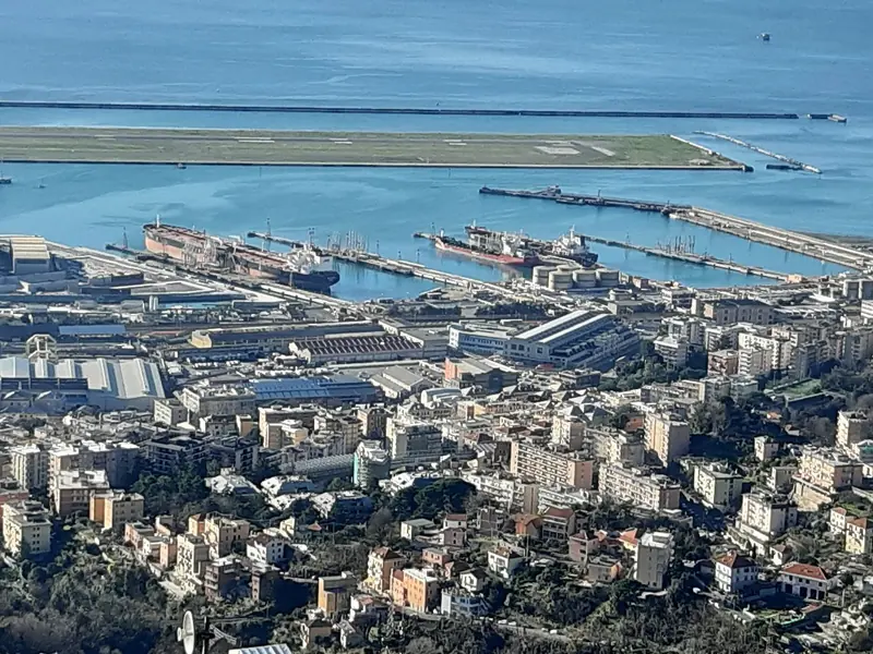 Sestri Ponente from the hill above it, the shipyard and the airport runway on the water the marina sits on.