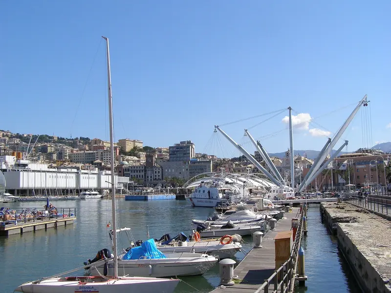 Cranes and pontoons in the old port. The refit trade around both basins is why many yachts come to Genoa at all.