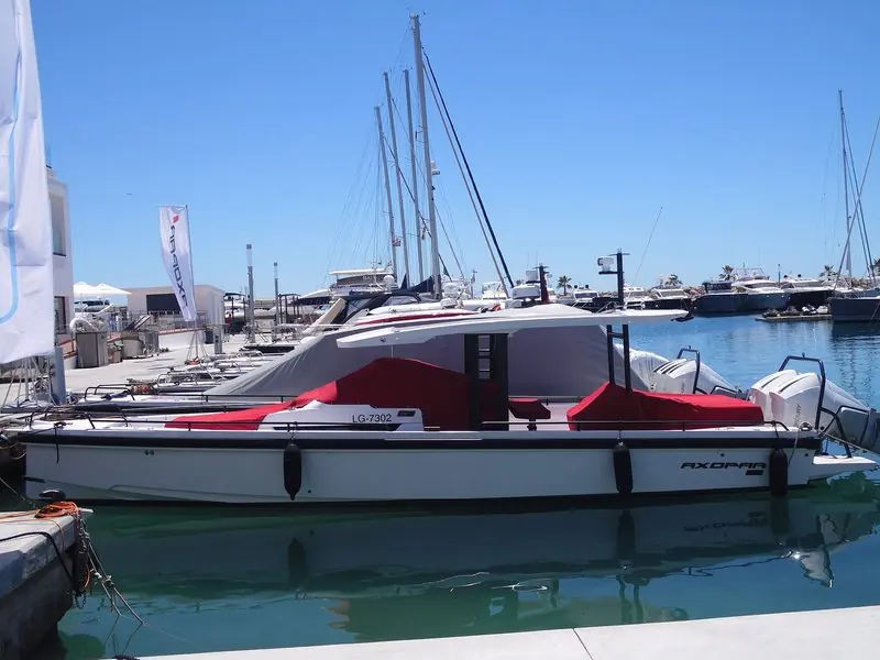 Outboard day boats take the short finger pontoons at Port Calanova, with cruising yachts and motor boats packed along the quays behind.