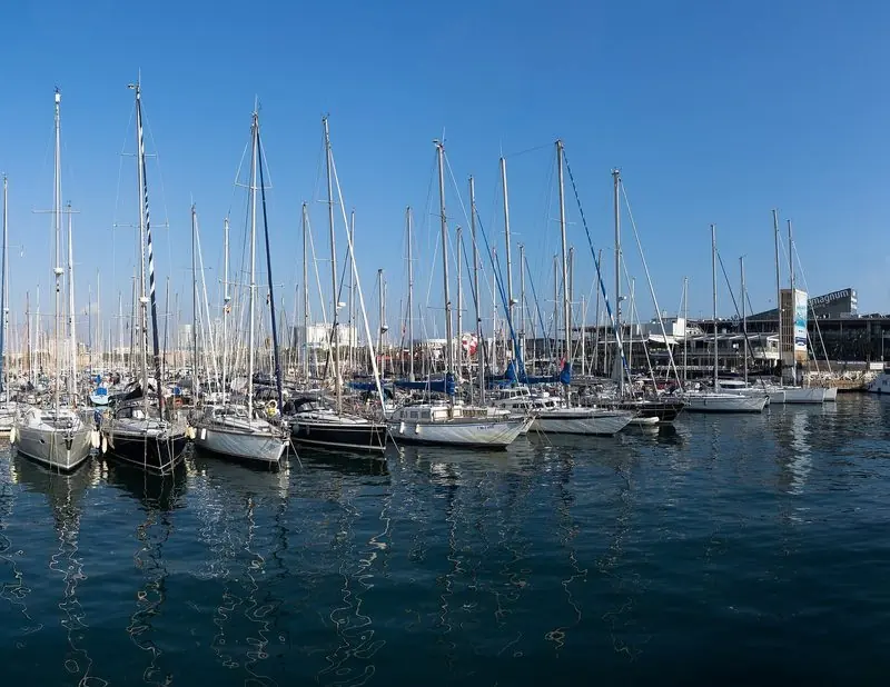 Sailing yachts fill the pontoons on the Maremagnum side of Port Vell, the shops and restaurants of the complex sitting directly across the water.