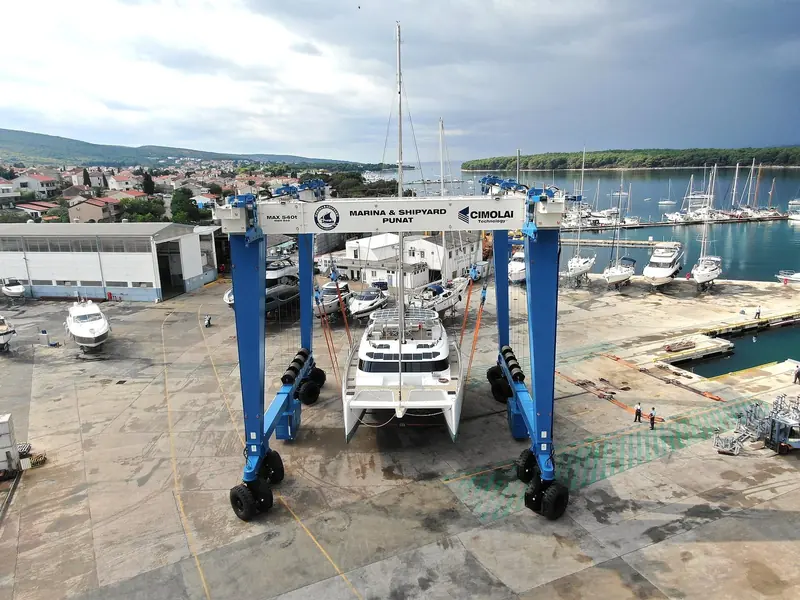 The Brodogradiliste Punat shipyard's travel lift at work, part of the haul-out and service yard behind the marina.