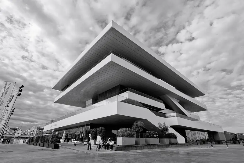 Veles e Vents in monochrome, the building's stacked cantilevered decks built to host the America's Cup teams and now the marina's landmark.
