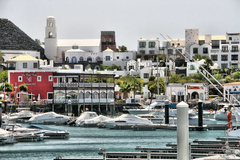The village's whitewashed, pan-tiled architecture, including the red-fronted La Casa Roja restaurant on the quay.