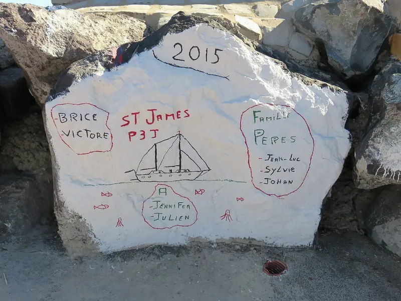 One of the hand-painted rocks left by past ARC crews on the marina breakwater, a tradition that has built up on the rip-rap at Las Palmas over decades.