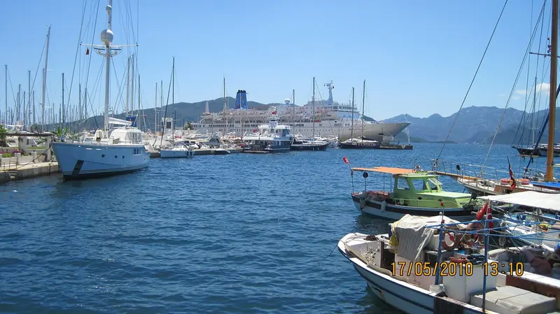 A motor yacht on the outer berths with the bay beyond.