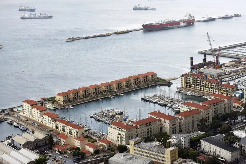 From the Rock the whole Marina Bay and Ocean Village complex lays out below, terraced apartments wrapped round three sides of the basin and the Bay of Gibraltar anchorage full of shipping beyond.
