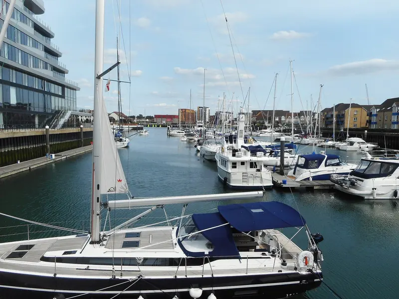 Yachts on the pontoons at Ocean Village, with the Southampton waterfront rising behind the basin.