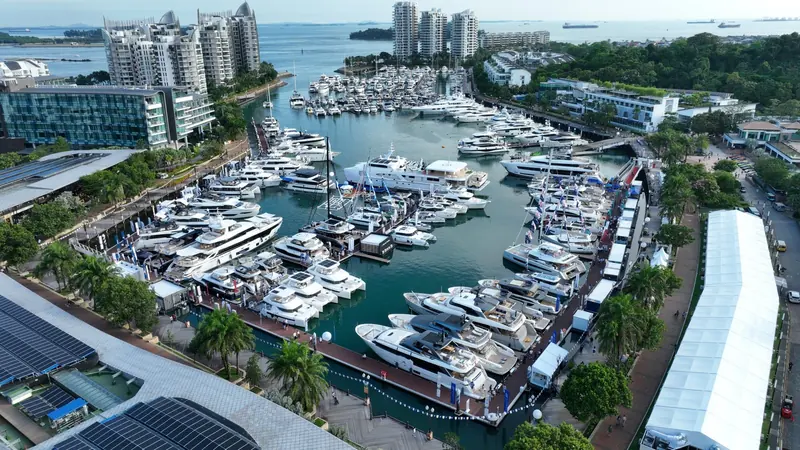 The whole basin from above with every pontoon taken and marquees set out along the quay for a boat show.