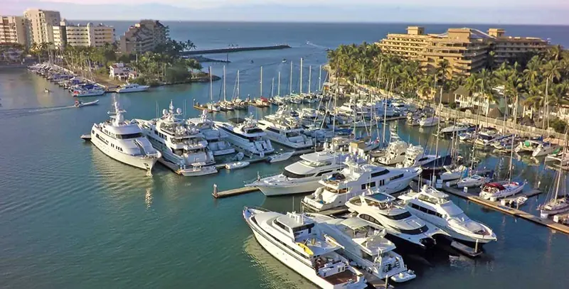 Motor yachts and sportfishers packed into the marina's fingers, with the Paradise Village towers on the point behind