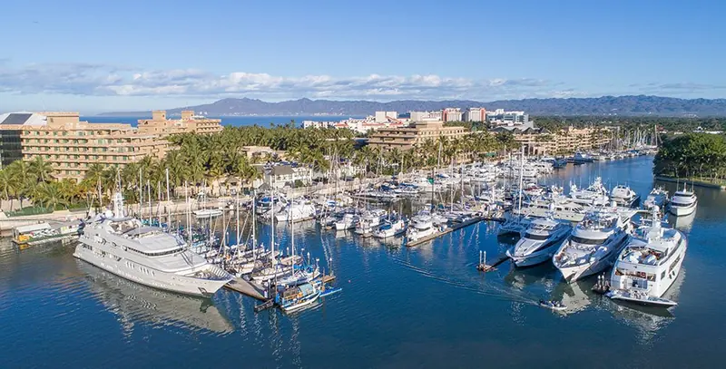 The marina basin looking out toward Banderas Bay, with the Sierra Madre foothills behind the bay