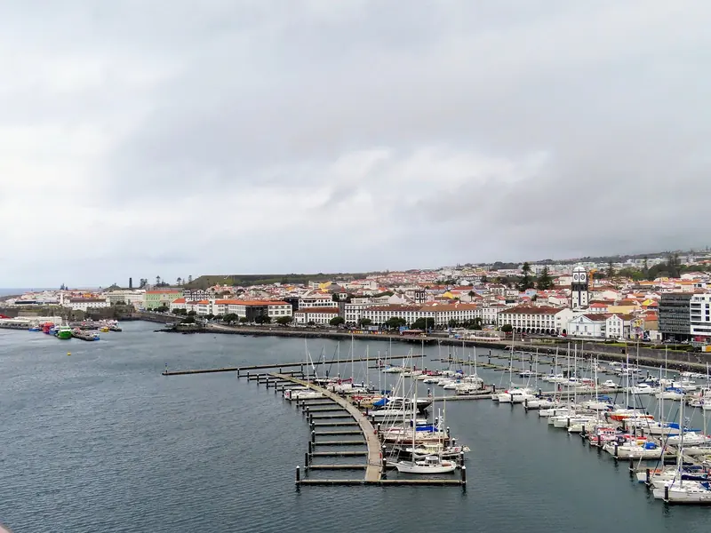 Ponta Delgada's waterfront and marina, seen from the water. The old town runs almost to the pontoons.