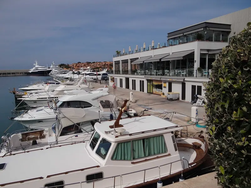 The dark low buildings on the quay are the Starck commercial terrace, with the pontoons running directly beneath them.