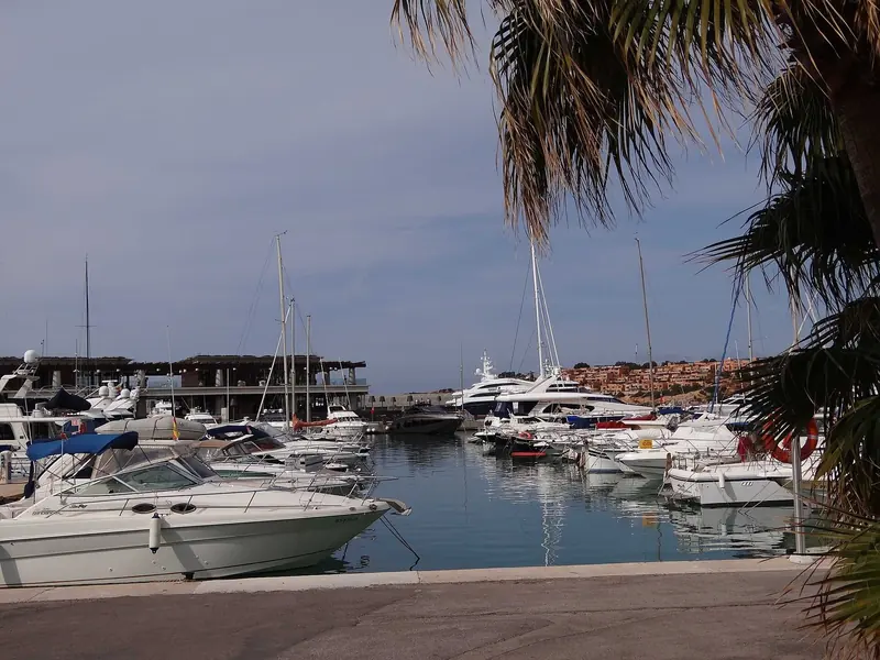 Motor yachts on the inner pontoons, the shops and restaurants along the quay behind.
