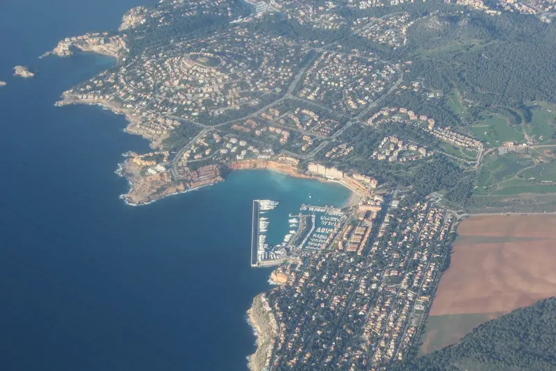 The El Toro headland from the air, with the marina cut into the shore below the village.