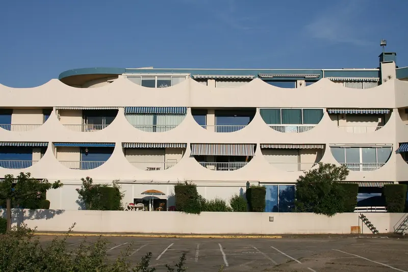 The scalloped 1970s balconies of Port Camargue's residential blocks, the pyramid-and-curve architecture the marina is known for.