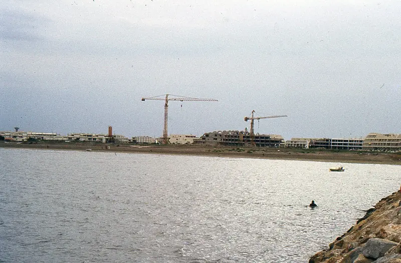 Port Camargue's first residential line rising from the sand in August 1983, cranes still over the unfinished marina.
