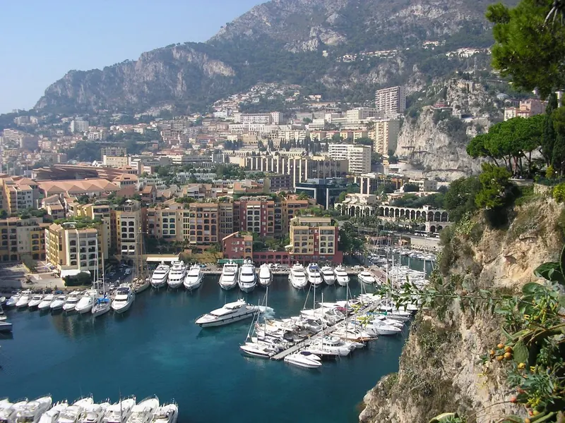 The close aerial shows what the marina's own figures describe: 275 berths inside a basin built where there used to be open sea, with reclaimed apartment blocks standing on the same fill.