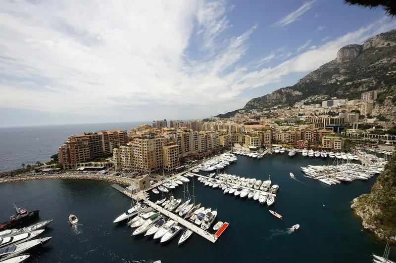 A quieter frame of the same basin, tenders and motor yachts on the inner pontoons. Nothing here is competing with Port Hercule's outer wall for size, and that is rather the point.