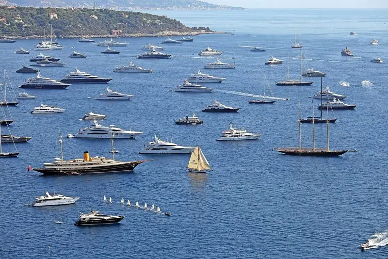 The anchorage outside the breakwater fills during show week, including the 1885 racing yacht Partridge.