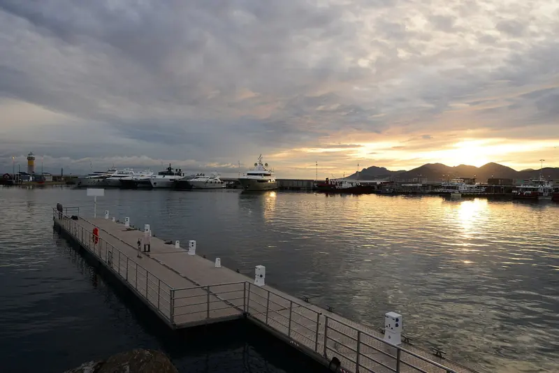 Sunset over the Vieux Port. The pontoons in the foreground are visitor berths, and the larger yachts lie beyond them on the outer wall.