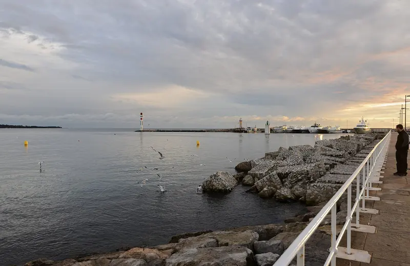 The breakwater walk at dusk. The seaward side of the port takes what a strong easterly pushes into the bay.