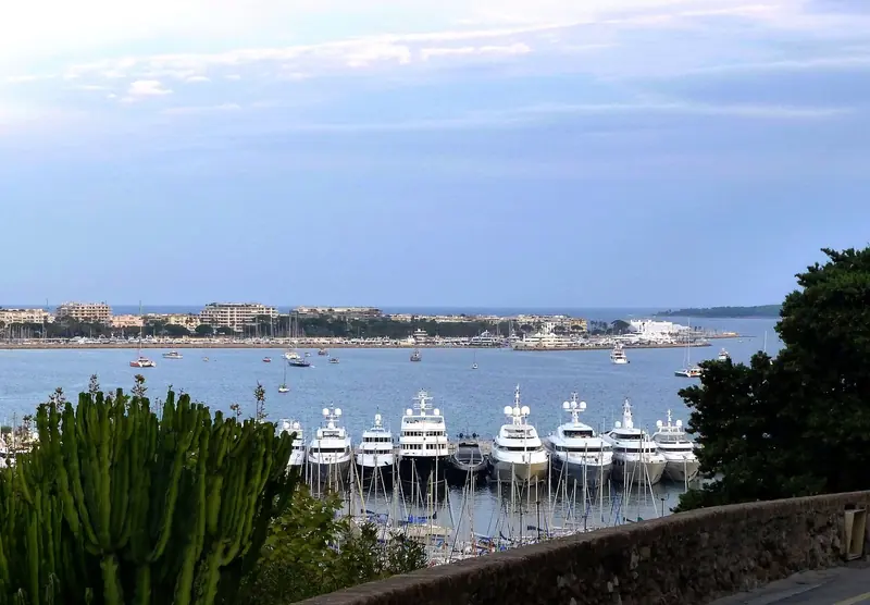 Yachts on the quay below the old town, the anchorage lying off in the bay behind them.