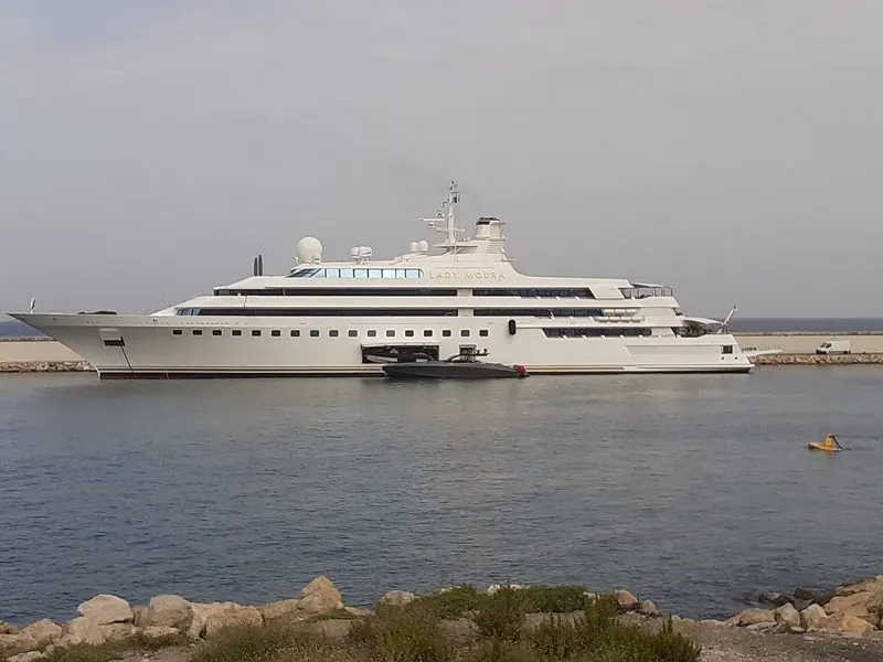 A large yacht moving off the harbour entrance.